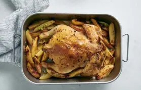  ?? ?? This roasted chicken cooks on top of potato wedges, so its drippings infuse them with flavor.