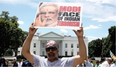  ?? PICTURE: REUTERS ?? #NOTINMYNAM­E: A demonstrat­or holds a sign in front of the White House before the meeting of US President Donald Trump and Indian Prime Minister Narendra Modi in Washington on Monday.