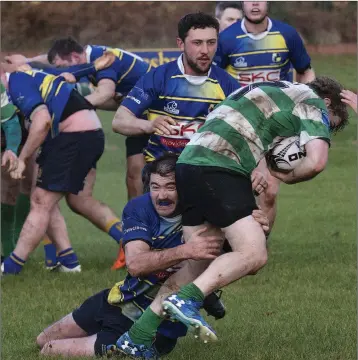  ??  ?? Rathdrum’s Danny Dowling refuses to be beaten during the clash with Naas.
Photos: Noel McMullen