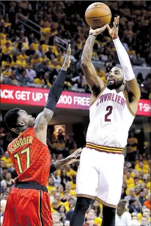  ?? AP/ TONY DEJAK ?? Cleveland guard Kyrie Irving ( right) pulls up for a jumper in front of Atlanta defender Dennis Schroder during the second half of Monday night’s NBA playoff game. Irving and the Cavaliers held off a late Hawks’ rally to grab a 104- 93 victory and take a 1- 0 lead in their Eastern Conference semifi nal series.