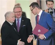  ?? JANEK SKARZYNSKI / AFP / GETTY IMAGES ?? Mateusz Morawiecki, right, newly designated as Poland’s prime minister, greets the leader of the Law and Justice party Jaroslaw Kaczynski in Warsaw on Friday. Few people are discussing Poland following Britain out of the EU, but a protracted conflict...