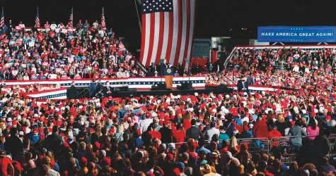  ?? AFP ?? Above: President Donald Trump speaks at a campaign rally in Macon, Georgia, at theweekend.
Below: Twowomen take a selfie next to a Trump bus in the parking lot of the campaign rally.