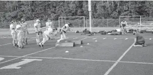  ?? JASON SIMMONDS • THE GUARDIAN ?? Chris Williams, defensive co-ordinator with Team P.E.I.’s under-18 squad, works with the linemen during a practice at the Terry Fox Sports Complex in Cornwall on July 14. Football P.E.I. is sending under-16 and under-18 teams to the Atlantic Bowl tournament in Antigonish, N.S., July 21-24.