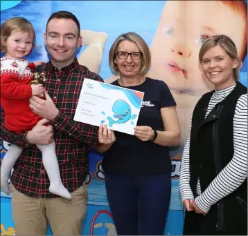  ??  ?? Carol McNally from Water Babies with Hannah McGinn and her parents Jennifer and Brian.