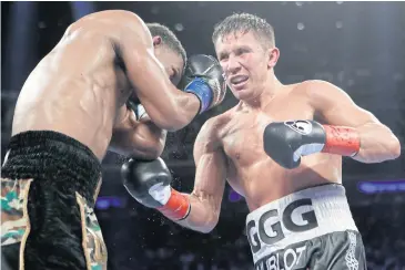  ?? AP ?? Gennady Golovkin punches Daniel Jacobs during the 11th round.
