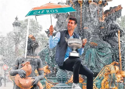  ??  ?? French Open champion Novak Djokovic celebrates his victory over Andy Murray at the Place de la Concorde in Paris yesterday.