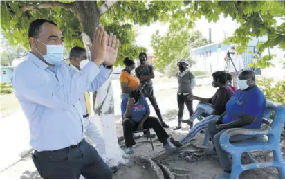  ?? (Photo: JIS) ?? Health and Wellness Minister Dr Christophe­r Tufton speaks with residents and staff at the Golden Age Home, Vineyard Town, St Andrew, during an inspection of the facility on Monday.