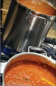  ?? PHOTO BY EMILY RYAN ?? Tomato sauce simmers on the stove.