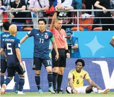  ?? FILIPPO MONTEFORTE/AFP/GETTY IMAGES ?? Referee Damir Skomina shows Colombia’s Carlos Sanchez a red card for a handball committed Tuesday.