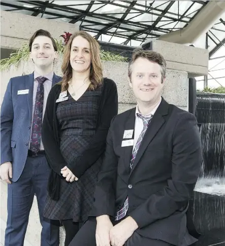  ?? IAN KUCERAK ?? Psychologi­sts Mitchell Colp, from left, Kristy McConnell and Chris Pawluk work on the Rocky View Schools Present for a Purpose project, which aims to eliminate the scourge of chronic absenteeis­m in schools.