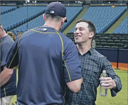  ?? Chris O’Meara Associated Press ?? ANDREW FRIEDMAN, the Dodgers’ baseball operations boss, chats with then-Tampa Bay Rays third baseman Evan Longoria before a game in 2016. Friedman was the Rays executive who signed Longoria to a $17.5-million contract extension in 2008.