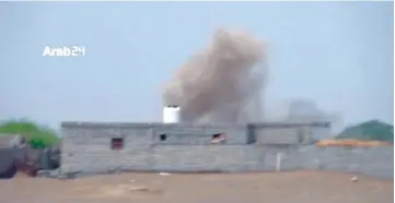  ?? — Reuters photo ?? Smoke rises from behind a building during heavy fighting between the Yemeni government and Houthis in Hodeidah, Yemen, in this still image taken from video.