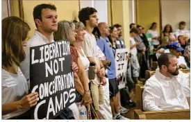  ?? RALPH BARRERA / AMERICAN-STATESMAN ?? Several protesters, including (from left) Kate Schneider and Kevin Sampson of Austin, packed the Williamson County Courthouse in Georgetown in June to show their opposition to the detention center.