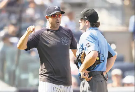  ?? Mary Altaffer / Associated Press ?? New York Yankees manager Aaron Boone, right, argues with home plate umpire Ben May after being ejected during the sixth inning against the Indians on Saturday.