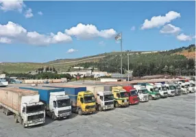  ?? GHAITH ALSAYED/AP FILE ?? Trucks loaded with United Nations humanitari­an aid for Syria are parked at the Bab al-hawa border crossing with Turkey on Feb. 10.