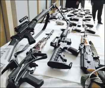  ?? M. SPENCER GREEN/THE ASSOCIATED PRESS FILE ?? Firearms are displayed at the Chicago FBI office in July 2010. A new poll shows most young adults across racial and ethnic groups support tighter gun policies, including background checks, stricter penalties for gun law violations and banning...