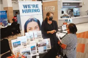  ?? AP PHOTO/MARTA LAVANDIER ?? Marriott human resources recruiter Mariela Cuevas, left, talks to Lisbet Oliveros during an early September job fair at Hard Rock Stadium in Miami Gardens, Fla.