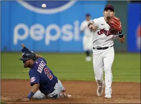  ?? TONY DEJAK — THE ASSOCIATED PRESS ?? Andres Gimenez throws to first after forcing out the Twins’ Luis Arraez at second during the eighth inning. Byron Buxton was safe at first.