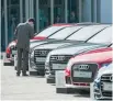  ?? — Reuters ?? A man checks a car at Audi’s showroom in Shanghai.