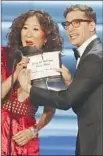  ??  ?? SANDRA OH presents an award with Andy Samberg.