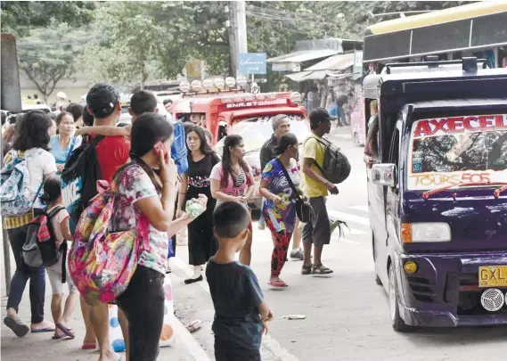  ?? SUNSTAR FOTO / ALLAN CUIZON ?? THE STRUGGLE IS REAL. The commuting public has to wrestle every day with the routine of having to wait long and literally chase their chances of getting a seat in jeepneys and passenger vehicles.