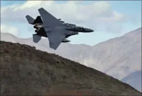  ?? THE ASSOCIATED PRESS ?? In this file photo, an F-15E Strike Eagle flies out of the nicknamed Star Wars Canyon turning toward the Panamint range over Death Valley National Park, Calif. Military jets roaring over national parks have long drawn complaints from hikers and campers.
