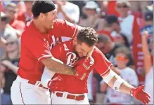  ?? David Kohl ?? Cincinnati Reds right fielder Albert Almora Jr. (right) celebrates with center fielder Nick Senzel (left) after hitting the game winning RBI single against the Braves at Great American Ball Park in Cincinnati on Sunday.