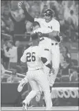  ?? FRANK FRANKLIN II | ASSOCIATED PRESS ?? NEW YORK’S Aaron Hicks celebrates with teammates after hitting an RBI double during the eleventh inning Sunday night in New York.