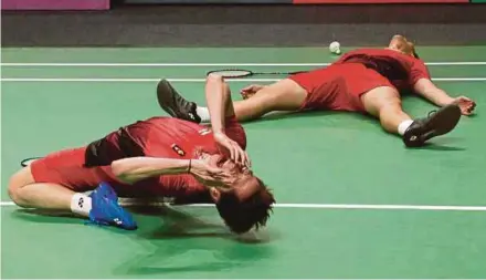  ?? EPA PIC ?? Indonesian players Kevin Sanjaya Sukamuljo (left) and Marcus Fernaldi Gideon, aka ‘Minions’ react after winning the doubles final at the Asian Games yesterday.