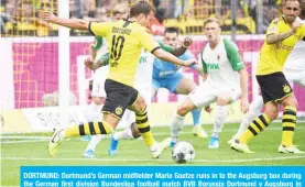  ??  ?? DORTMUND: Dortmund’s German midfielder Mario Goetze runs in to the Augsburg box during the German first division Bundesliga football match BVB Borussia Dortmund v Augsburg in Dortmund, western Germany yesterday. — AFP