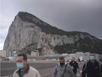  ??  ?? People cross the Spanish border of the British overseas territory of Gibraltar.