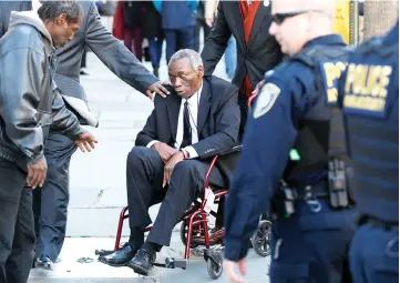  ??  ?? John Pinckney (centre) father of Emanuel Church shooting victim Rev. Clementa Pinckney, leaves the Charleston Federal Courthouse after Dylann Roof was found guilty on 33 counts including hate crimes in Charleston. — Reuters photo