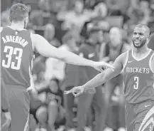  ?? Michael Ciaglo / Houston Chronicle ?? Forward Ryan Anderson (33) and guard Chris Paul congratula­te each other at the end of the Rockets’ 50-point third quarter.