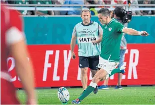  ?? AFP ?? Ireland fly-half Jonathan Sexton hits and scores a try conversion during the Pool A match against Russia in Kobe.