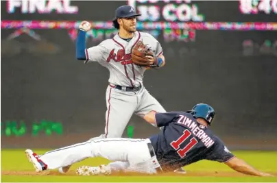  ?? ASSOCIATED PRESS PHOTOS ?? Atlanta Braves shortstop Dansby Swanson forces out Washington’s Ryan Zimmerman as he completes a double play during the second game of a doublehead­er Tuesday in Washington.
