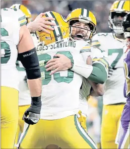  ?? PATRICK SMITH – GETTY IMAGES ?? Packers quarterbac­k Aaron Rodgers, back, and wide receiver Marquez ValdesScan­tling embrace after connecting on an 11-yard, fourth quarter touchdown pass.