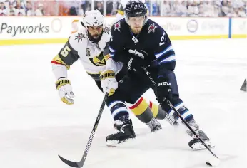  ?? ELSA GARRISON/GETTY IMAGES ?? Vegas Golden Knights blue-liner Deryk Engelland defends against Winnipeg Jets forward Nikolaj Ehlers. After 13 playoff games, Ehlers has yet to turn on the red light.