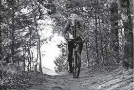  ?? [PHOTO BY CHRIS LANDSBERGE­R, THE OKLAHOMAN] ?? James Pratt rides his mountain bike at Lake Arcadia as he gets some cross training time in while he prepares to run the Oklahoma City Memorial Marathon.