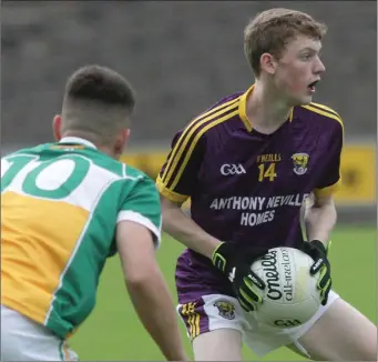  ??  ?? Michael Carroll sizes up his options as Conor McCarthy (Offaly) moves in.