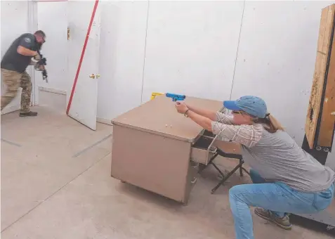  ?? Picture: AP/RICK BOWMER ?? Utah schoolteac­her Christy Belt engages in an active shooter response exercise