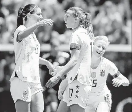  ?? ELSA/GETTY ?? Alex Morgan, Tobin Heath and Megan Rapinoe and the rest of the U.S. women’s team will defend their title at the World Cup in France.