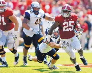  ?? BRYNN ANDERSON/ASSOCIATED PRESS ?? Alabama freshman running back Joshua Jacobs runs through the Kent State defense in the first half Saturday in Tuscaloosa, Ala. Jacobs had 97 yards in the victory.