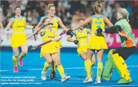  ?? Picture: GETTY IMAGES ?? Hockeyroos players mob Brooke Peris after her winning penalty against Argentina.