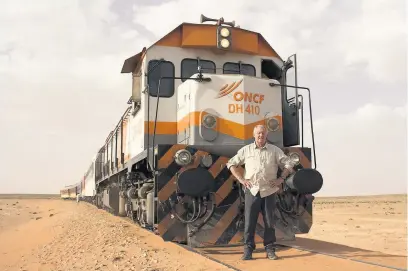  ??  ?? Chris Tarrant in front of the desert train in Morocco