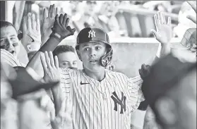  ?? Robert Sabo ?? GIVE HIM A HAND: Gio Urshela is congratula­ted in the dugout after hitting a solo homer on Sunday. He is hitting .333 with a .950 OPS over his past eight appearance­s since Sept. 12.