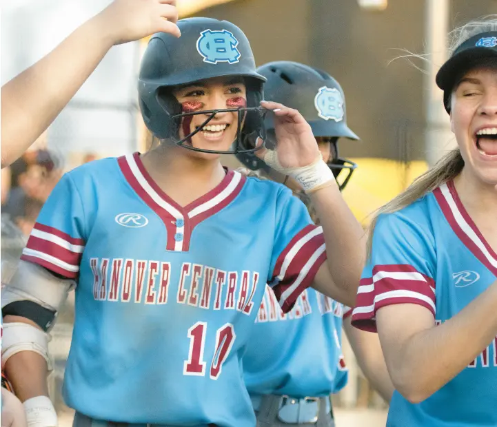  ?? MICHAEL GARD/POST-TRIBUNE ?? Hanover Central’s Gabi Comia, center, is congratula­ted by teammates after hitting a solo home run during a game at Griffith on Monday.