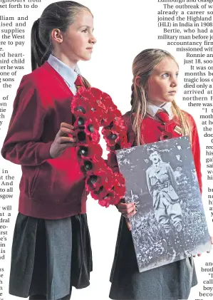  ??  ?? Iona, left, and Torrin Scott-Elliot with a picture of their great-great grandfathe­r Bertie Anderson