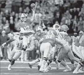  ?? Andy Lyons Getty Images ?? WISCONSIN QUARTERBAC­K Alex Hornibrook jumps as he passes during Saturday’s game against Ohio State. He finished with 229 yards passing.