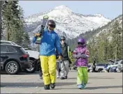  ??  ?? BRET McTIGUE and daughter Taylor at Sierra-atTahoe Ski Resort last month. All but one river draining the west slope of the Sierra has at least one dam.