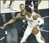  ?? KEVIN REECE Special to the Valley Press ?? The Clippers’ Paul George tries to find an opening against the Warriors’ Stephen Curry during Sunday’s game at Staples Center. The Warriors won 105-90.